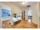 Hallway with wood floors leading to bedrooms with neutral colored walls at 4445 Blue Major Dr, Windermere, FL 34786