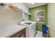 Laundry room featuring washer, dryer, storage cabinets, and a window at 4445 Blue Major Dr, Windermere, FL 34786