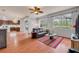 Open living room featuring wood floors, natural light, and seamless flow into the adjacent kitchen and dining area at 4445 Blue Major Dr, Windermere, FL 34786