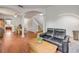 Open-concept living room with hardwood floors, staircase, and views into the kitchen and dining area at 4445 Blue Major Dr, Windermere, FL 34786