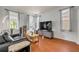 Comfortable living room with hardwood floors and a large TV at 4445 Blue Major Dr, Windermere, FL 34786