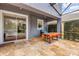 Covered patio with stone floors, features outdoor seating and a view of the pool at 4445 Blue Major Dr, Windermere, FL 34786
