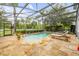 Screened-in pool with a spa, stone tile, and a lounge chair, offering a perfect outdoor oasis at 4445 Blue Major Dr, Windermere, FL 34786