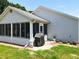 View of the home's screened-in lanai and neat backyard at 4521 Eaglewood Dr, Leesburg, FL 34748