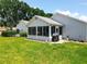 The spacious backyard with a screened-in lanai is ideal for relaxing and entertaining at 4521 Eaglewood Dr, Leesburg, FL 34748