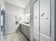Bright bathroom featuring double vanity with lots of storage, elegant lighting, and framed mirror at 4521 Eaglewood Dr, Leesburg, FL 34748