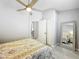 Bedroom with a ceiling fan, spacious closet, and full-length mirror, offering both comfort and practicality at 4521 Eaglewood Dr, Leesburg, FL 34748