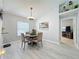 Elegant dining room with a modern chandelier, light wood flooring, and serene decor at 4521 Eaglewood Dr, Leesburg, FL 34748