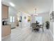 Open-concept dining area with views of the kitchen and the entryway at 4521 Eaglewood Dr, Leesburg, FL 34748
