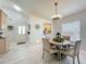 Charming dining area with a round table, views to the kitchen, and light wood flooring at 4521 Eaglewood Dr, Leesburg, FL 34748
