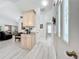 Welcoming entryway showcasing light wood-look flooring and natural light, leading to other rooms at 4521 Eaglewood Dr, Leesburg, FL 34748