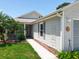 Landscaped front yard with walkway leading to the entrance of the light gray sided home at 4521 Eaglewood Dr, Leesburg, FL 34748