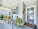 Inviting front porch with seating area and decorative plants, next to the home's front door at 4521 Eaglewood Dr, Leesburg, FL 34748