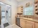 Bright kitchen featuring stainless steel appliances, tiled backsplash, and a window providing natural light at 4521 Eaglewood Dr, Leesburg, FL 34748