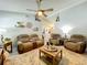 Comfortable living room features neutral walls, a ceiling fan, and plush seating at 4521 Eaglewood Dr, Leesburg, FL 34748