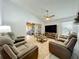 Cozy living room featuring comfortable seating, a ceiling fan, and sliding glass doors to the lanai at 4521 Eaglewood Dr, Leesburg, FL 34748