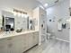 Beautiful main bathroom with double vanity, a shower, and neutral decor at 4521 Eaglewood Dr, Leesburg, FL 34748