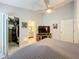Bright main bedroom featuring a walk-in closet, tv, and a neutral color scheme at 4521 Eaglewood Dr, Leesburg, FL 34748