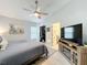 Relaxing main bedroom featuring a ceiling fan, TV, and a closet for ample storage at 4521 Eaglewood Dr, Leesburg, FL 34748