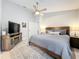 Bright main bedroom with a ceiling fan, a tv, and neutral walls at 4521 Eaglewood Dr, Leesburg, FL 34748