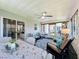 Bright sunroom offering versatile space for relaxation and dining, featuring a ceiling fan and lots of natural light at 4521 Eaglewood Dr, Leesburg, FL 34748