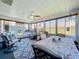 Bright sunroom featuring a ceiling fan, many windows, and a dining table set for comfortable, year-round enjoyment at 4521 Eaglewood Dr, Leesburg, FL 34748
