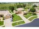 Expansive aerial view reveals a stucco home with a lush lawn, long driveway, and mature trees in a serene setting at 4548 Barrister Dr, Clermont, FL 34711