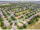 Aerial view of neighborhood with tree lined streets, well maintained lawns and mature trees at 4548 Barrister Dr, Clermont, FL 34711