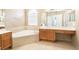 Large bathroom boasts a soaking tub, shower, and vanity with drawers at 4548 Barrister Dr, Clermont, FL 34711