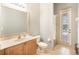 Clean bathroom with shower, toilet, sink, and an exit to the pool area at 4548 Barrister Dr, Clermont, FL 34711