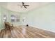 Airy bedroom showcases wood floors, a ceiling fan and abundant light at 4548 Barrister Dr, Clermont, FL 34711