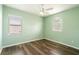 This cozy bedroom has two windows and hardwood floors at 4548 Barrister Dr, Clermont, FL 34711