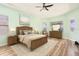 Staged bedroom features wood flooring, a ceiling fan and complementary furniture at 4548 Barrister Dr, Clermont, FL 34711