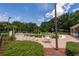 Community pool and lounge area with tables and chairs set amongst beautifully manicured landscaping at 4548 Barrister Dr, Clermont, FL 34711