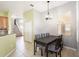 Dining area featuring a dark wood table with seating for six and staircase in the background at 4548 Barrister Dr, Clermont, FL 34711