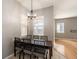 Dining area with a dark wood table, seating for six, and natural light from the windows at 4548 Barrister Dr, Clermont, FL 34711