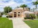 Stunning home features a spacious driveway, lush landscaping, and a meticulously maintained lawn at 4548 Barrister Dr, Clermont, FL 34711