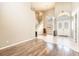 Spacious foyer offers high ceilings, a staircase, neutral walls, hardwood floors, and decorative front doors at 4548 Barrister Dr, Clermont, FL 34711