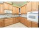 Kitchen featuring ample wooden cabinetry, granite countertops, and modern appliances at 4548 Barrister Dr, Clermont, FL 34711
