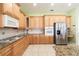 Modern kitchen boasting stainless steel appliances, granite countertops, and light wood cabinetry at 4548 Barrister Dr, Clermont, FL 34711