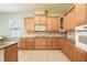 Well-equipped kitchen with wooden cabinets, granite countertops, and tile backsplash at 4548 Barrister Dr, Clermont, FL 34711