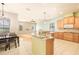 Bright, open kitchen featuring an island with granite countertops, wooden cabinets, and tile flooring at 4548 Barrister Dr, Clermont, FL 34711