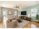 Inviting living room featuring a ceiling fan and lots of natural light and modern furnishings at 4548 Barrister Dr, Clermont, FL 34711