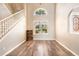 Spacious living area features natural lighting, neutral walls, modern vinyl flooring, and an arched window at 4548 Barrister Dr, Clermont, FL 34711