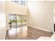 Empty room features high ceilings and large sliding glass doors leading to the pool and backyard at 4548 Barrister Dr, Clermont, FL 34711