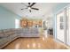 View of living room and kitchen with wood floors, ceiling fan, and open layout at 4548 Barrister Dr, Clermont, FL 34711