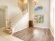 Open-concept living area displays staircase, natural lighting, neutral walls, and sleek vinyl flooring at 4548 Barrister Dr, Clermont, FL 34711