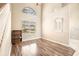 Bright living area with neutral walls, chandelier, vinyl flooring, arched windows, and views of front yard at 4548 Barrister Dr, Clermont, FL 34711