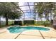 Enclosed pool area with a jacuzzi, landscaping, and space for outdoor entertainment at 4548 Barrister Dr, Clermont, FL 34711