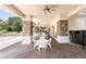 Comfortable poolside seating under a covered patio featuring ceiling fans and stone columns at 4548 Barrister Dr, Clermont, FL 34711